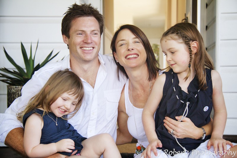 Family laughing on front steps - family portrait photography sydney